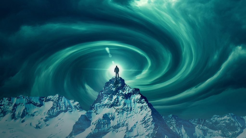 Man standing on mountain summit, decorative