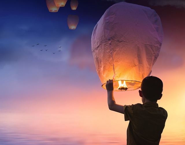 Boy holding up a lit lantern, passion, how to find your passion, joy, purpose