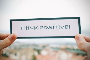 Piece of paper that says, "Think Positive," positive affirmations